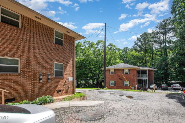 a kitchen with a refrigerator and a stove top oven