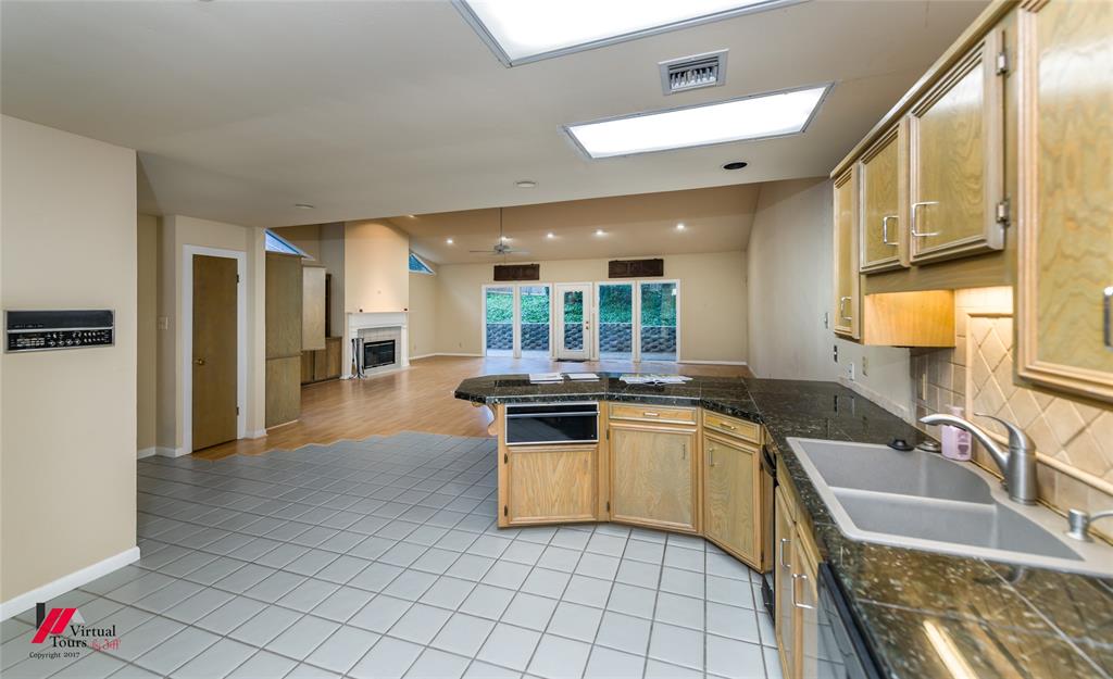 300 Pierremont Road, Unit 40 Shreveport, LA 71106 - Photo 16 of 34 Kitchen featuring granite countertops, wood cabinetry, tile flooring, and a double basin sink