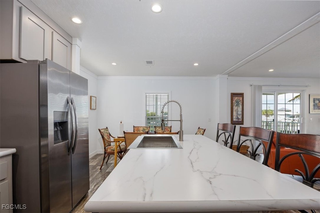 2801 York Road St. James City, FL 33956 - Photo 12 of 31 a living room with furniture a large window and stainless steel appliances