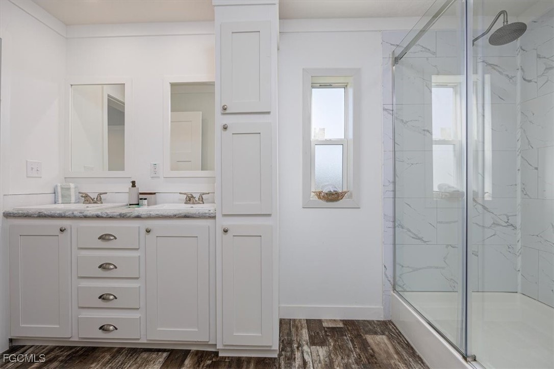 2801 York Road St. James City, FL 33956 - Photo 17 of 31 a bathroom with a granite countertop sink and a mirror