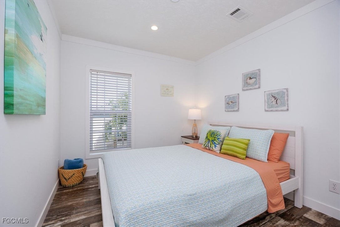 2801 York Road St. James City, FL 33956 - Photo 18 of 31 a bedroom with bed and window