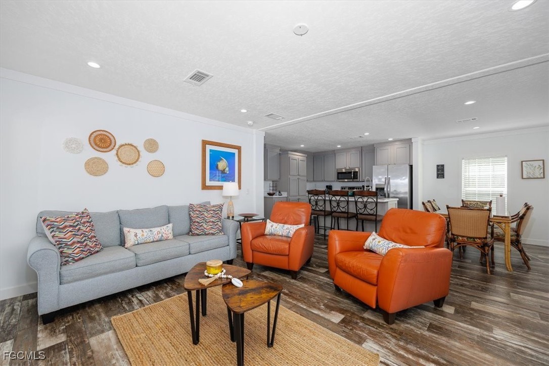 2801 York Road St. James City, FL 33956 - Photo 5 of 31 a living room with furniture kitchen view and a potted plant
