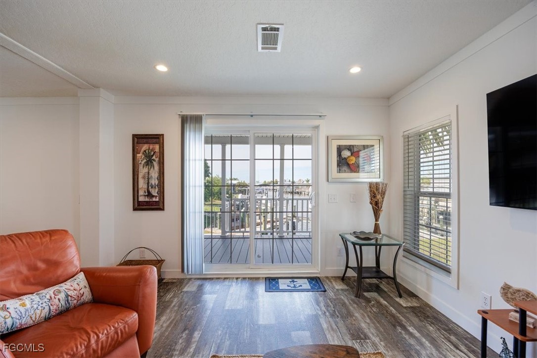 2801 York Road St. James City, FL 33956 - Photo 8 of 31 a living room with furniture and a flat screen tv