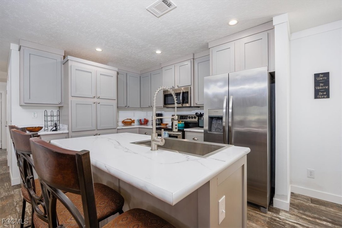 2801 York Road St. James City, FL 33956 - Photo 10 of 31 a kitchen with kitchen island a table and refrigerator