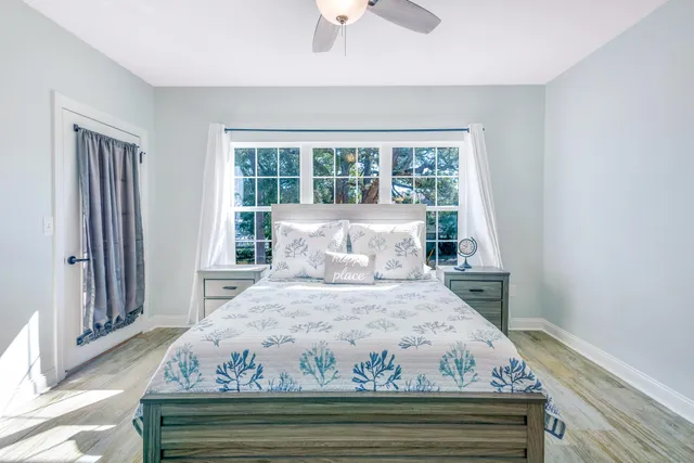 a bed sitting in a bedroom next to a window