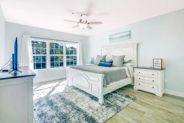 a bedroom with a large bed and a window