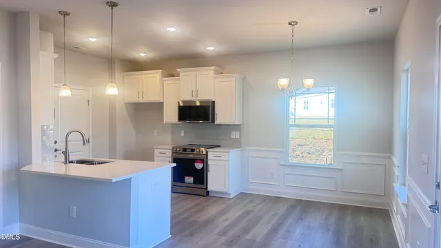 a kitchen with a stove a sink and a refrigerator