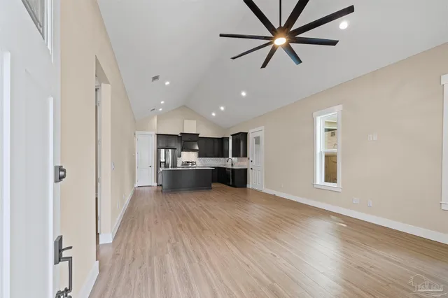a view of a kitchen with wooden floor and a kitchen