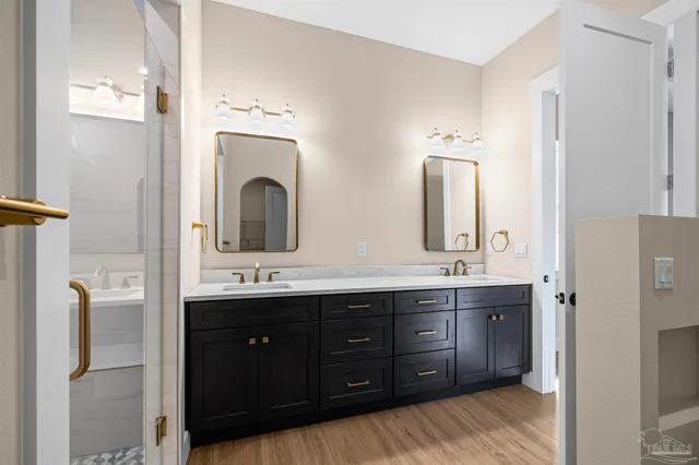 a bathroom with a double vanity sink and a large mirror
