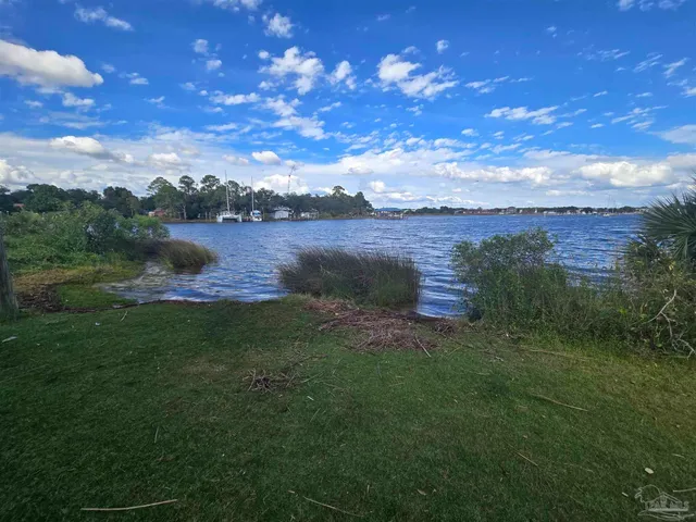 a view of a lake with houses in the back