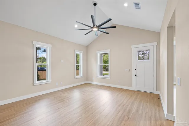 a view of a livingroom with a ceiling fan and window