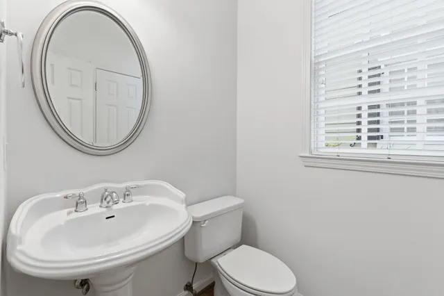 a view of a big room with windows and chandelier