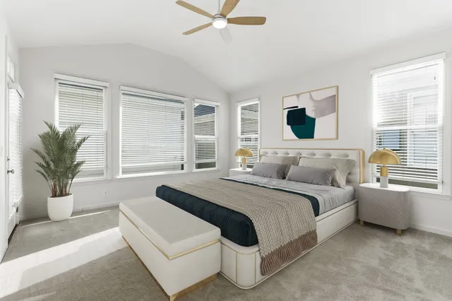 a spacious bedroom with a bed and a couch