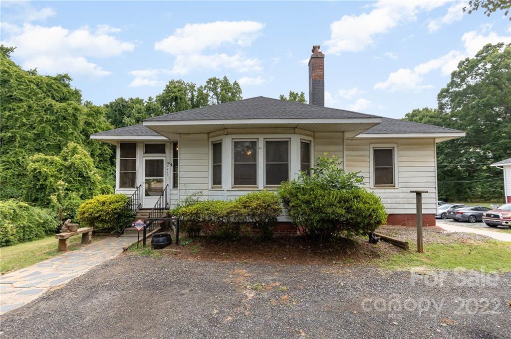 a front view of house with a garden