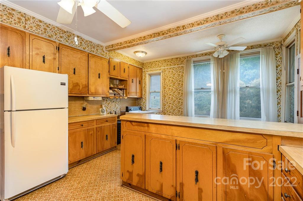8209 Moores Chapel Road Charlotte, NC 28214 - Photo 13 of 32 a kitchen with refrigerator a stove and a refrigerator