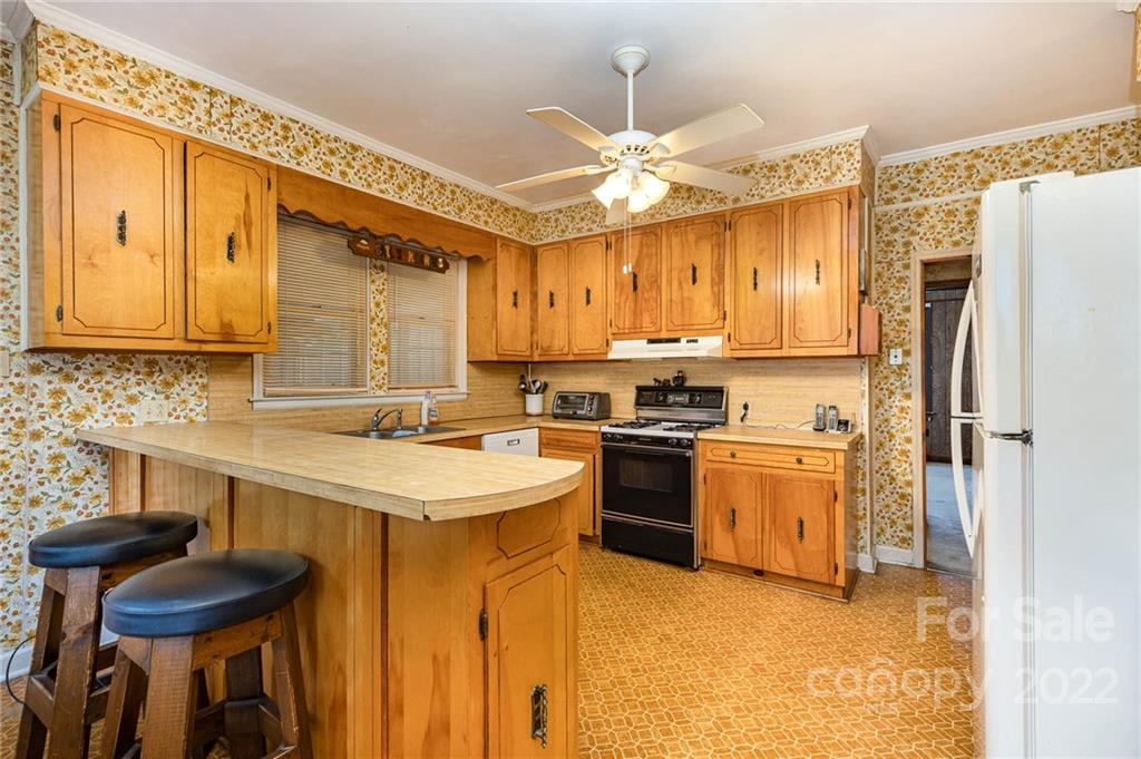 8209 Moores Chapel Road Charlotte, NC 28214 - Photo 14 of 32 a kitchen with a refrigerator and a sink