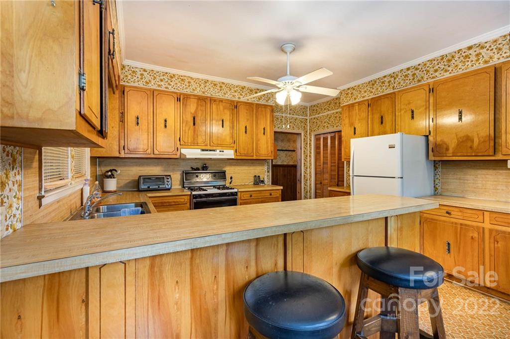 8209 Moores Chapel Road Charlotte, NC 28214 - Photo 15 of 32 a kitchen with stainless steel appliances a stove a sink and cabinets