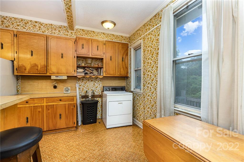 8209 Moores Chapel Road Charlotte, NC 28214 - Photo 16 of 32 a kitchen with stainless steel appliances granite countertop a stove and a refrigerator