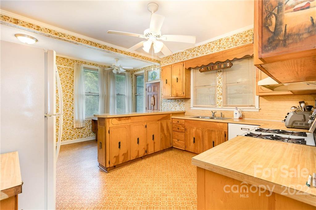 8209 Moores Chapel Road Charlotte, NC 28214 - Photo 17 of 32 a kitchen with stainless steel appliances granite countertop a sink and a stove