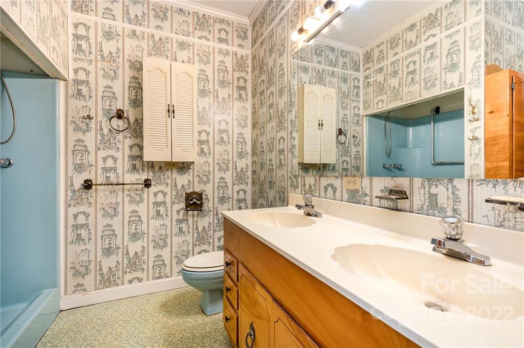 8209 Moores Chapel Road Charlotte, NC 28214 - Photo 18 of 32 a bathroom with a sink toilet double vanity and shower