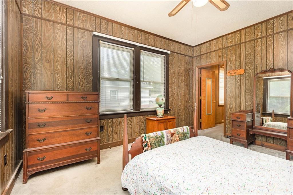 8209 Moores Chapel Road Charlotte, NC 28214 - Photo 20 of 32 a bedroom with a bed and wooden floor