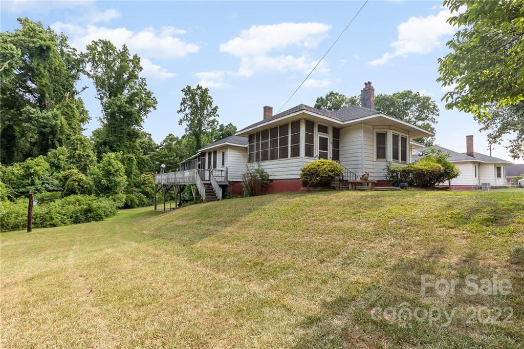 8209 Moores Chapel Road Charlotte, NC 28214 - Photo 2 of 32 a front view of a house with a garden