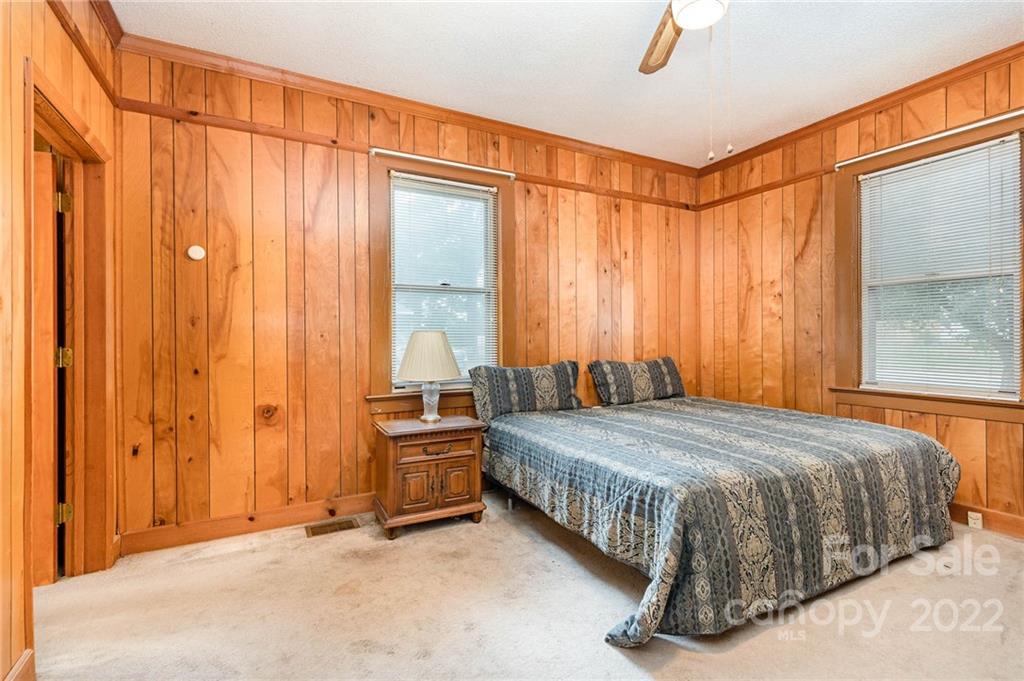 8209 Moores Chapel Road Charlotte, NC 28214 - Photo 22 of 32 a bedroom with a bed and a window