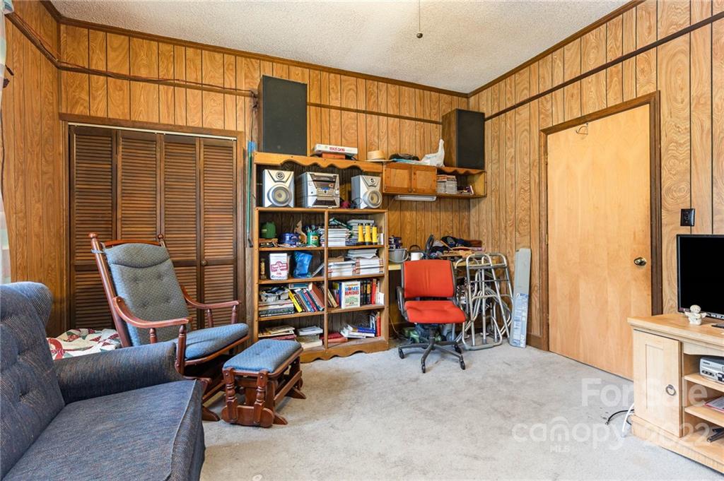 8209 Moores Chapel Road Charlotte, NC 28214 - Photo 5 of 32 a view of a workspace with furniture and a window