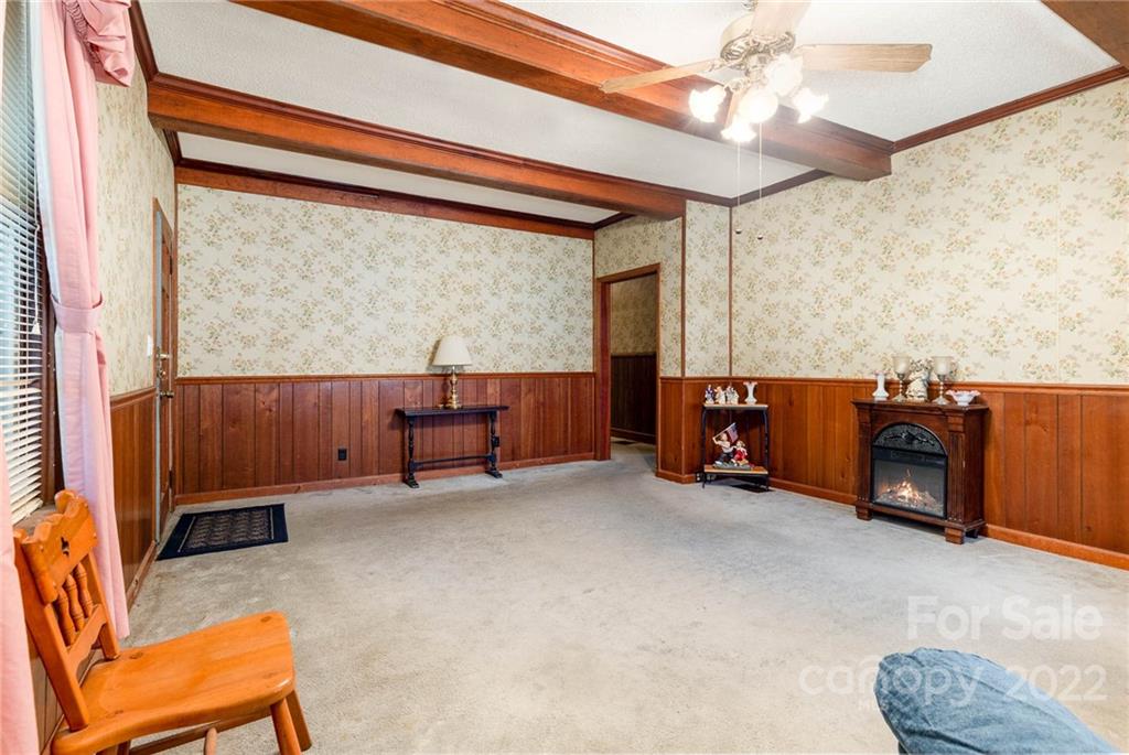8209 Moores Chapel Road Charlotte, NC 28214 - Photo 9 of 32 a view of room with furniture and a ceiling fan