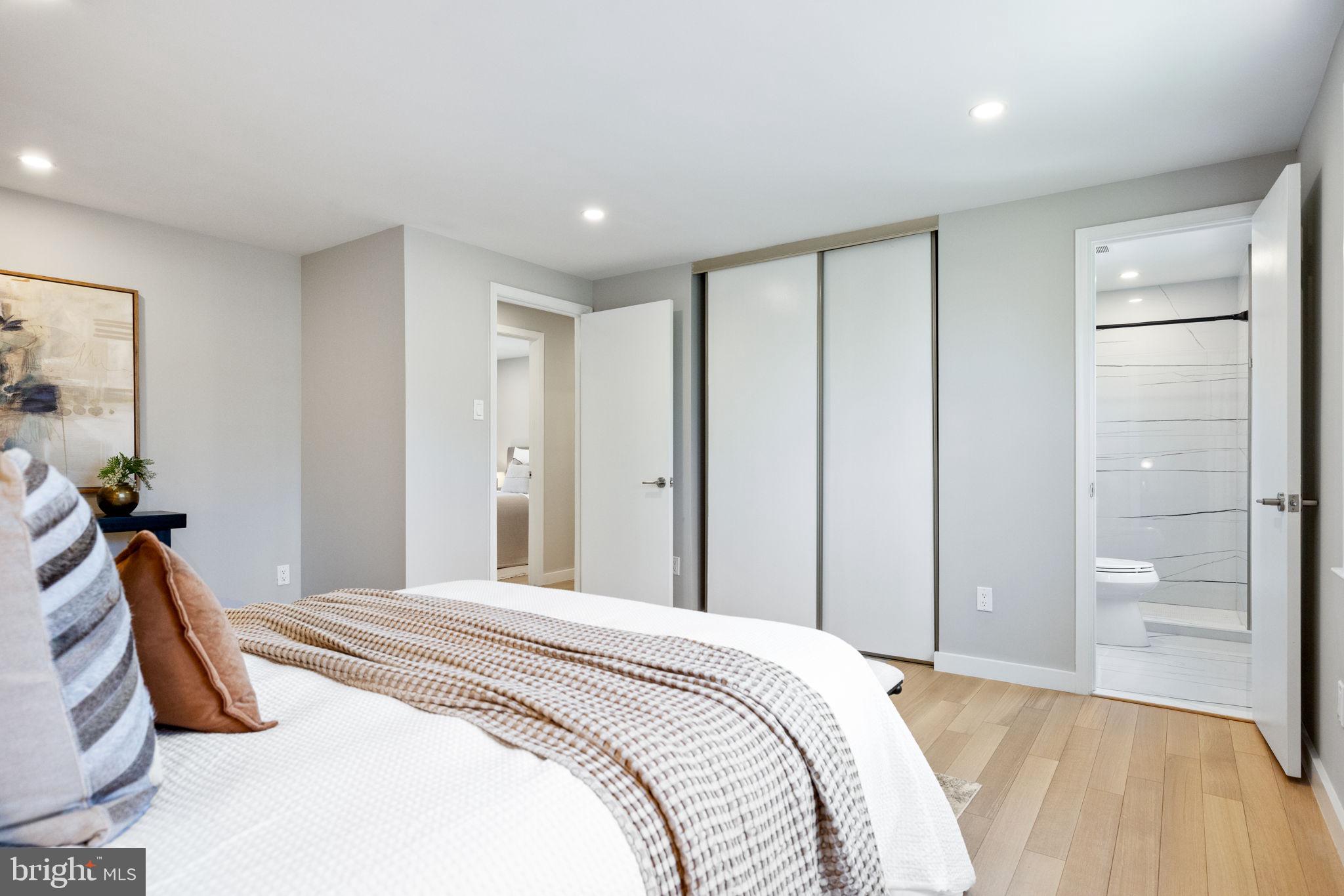 12870 Graypine Place Herndon, VA 20170 - Photo 13 of 35 a bedroom with a large bed and a chandelier