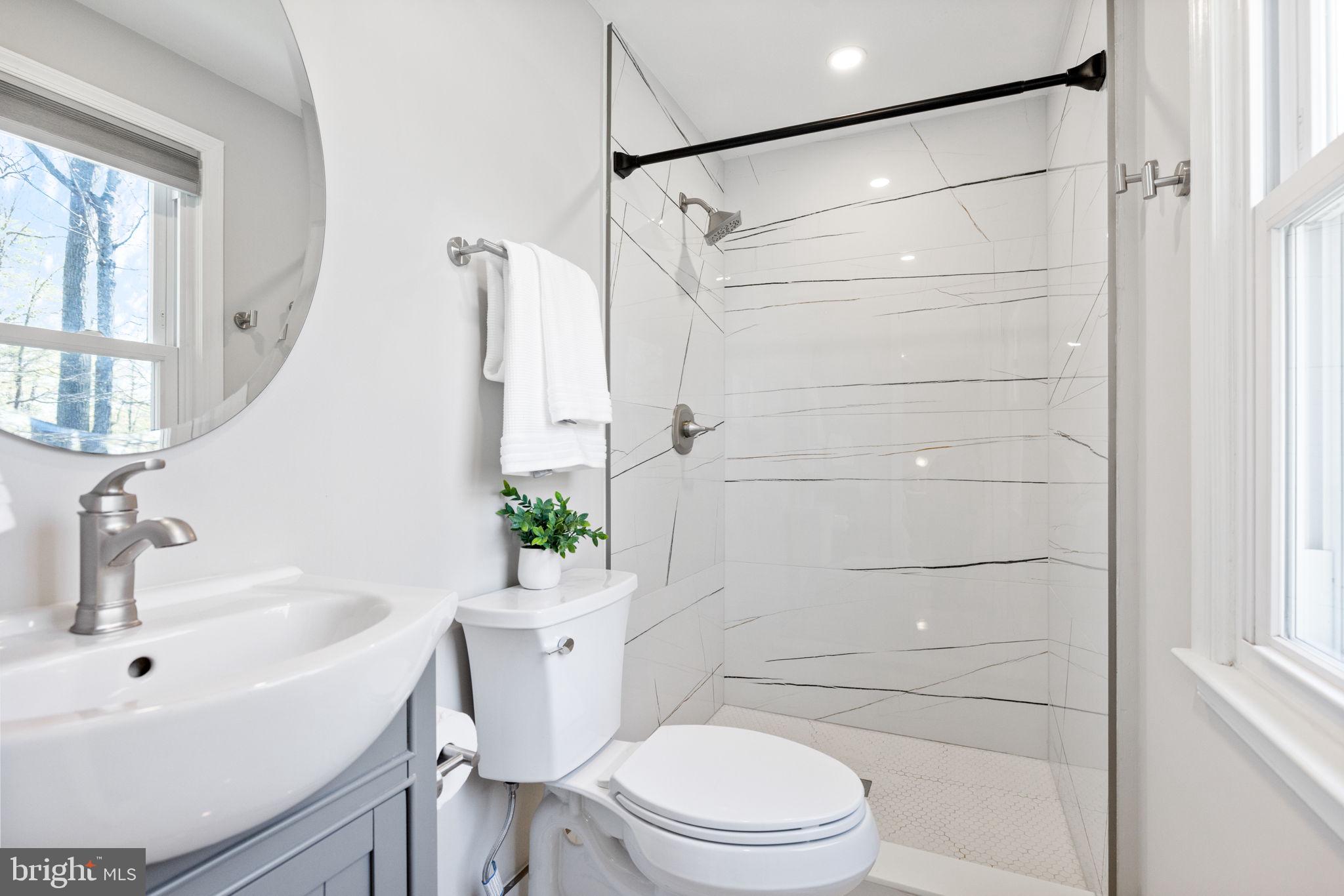 12870 Graypine Place Herndon, VA 20170 - Photo 15 of 35 a bathroom with a sink a toilet and shower