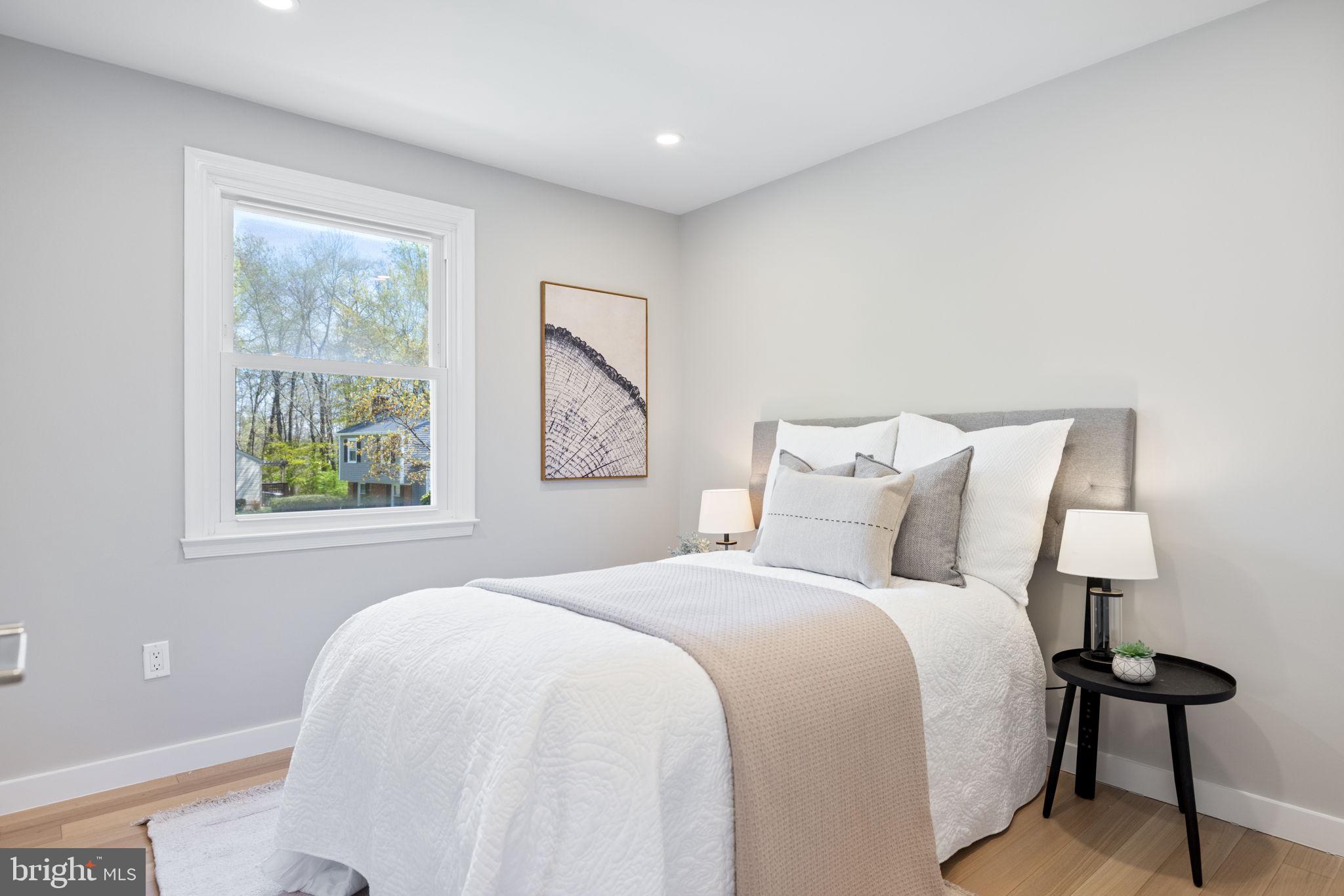 12870 Graypine Place Herndon, VA 20170 - Photo 17 of 35 a bedroom with a bed and a painting on the wall