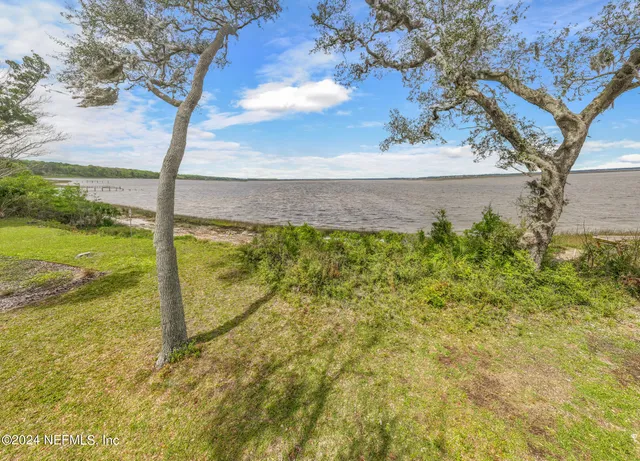 aerial view of a house with a garden and lake view