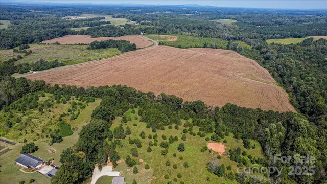 an aerial view of a house with a yard and lake view