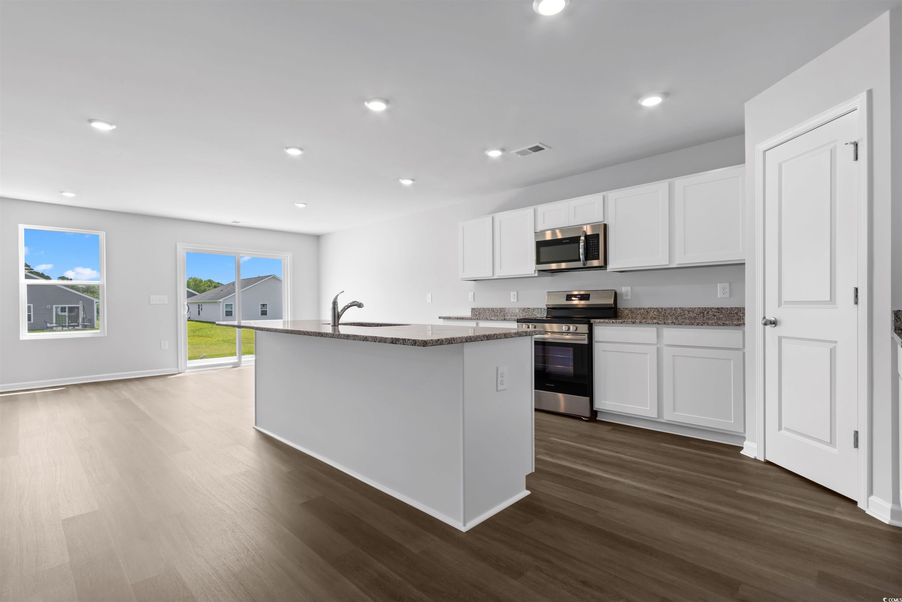 72 Cpe Pt Drive Conway, SC 29527 - Photo 19 of 34 Kitchen featuring white cabinets, an island with s