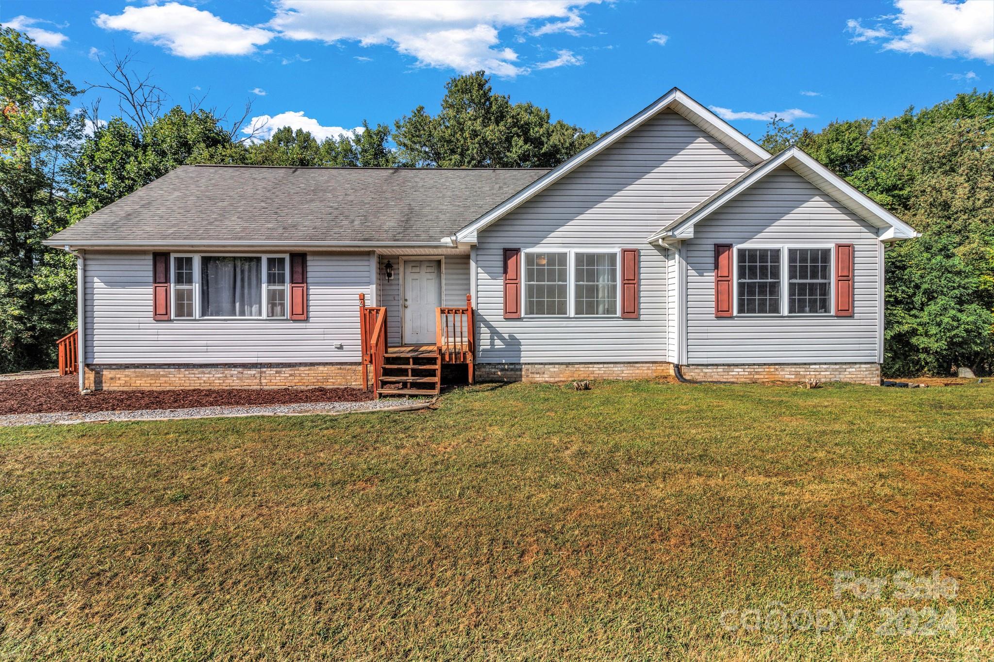 368 Richards Ridge Canton, NC 28716 - Photo 3 of 34 a front view of a house with garden