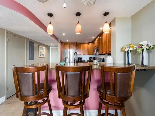 a living room with furniture kitchen and a chandelier