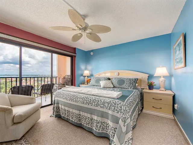 a bedroom with a bed a couch and a large window