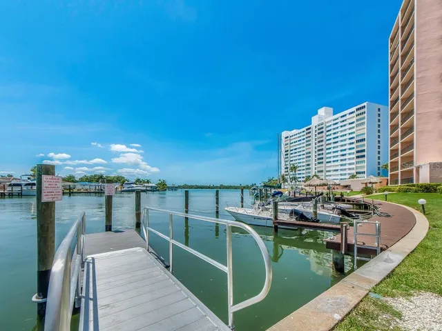 a view of a patio with chairs potted plants with wooden floor