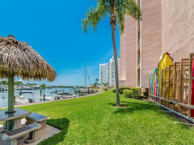 a view of a patio with couches and table and chairs under an umbrella