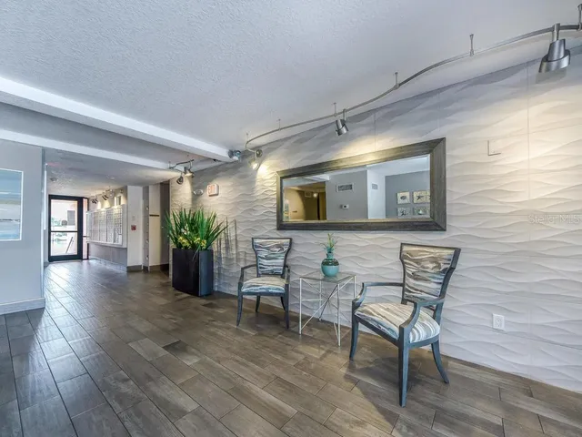 a view of a livingroom with furniture and a potted plant