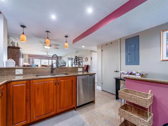 a kitchen with stainless steel appliances granite countertop a sink and cabinets