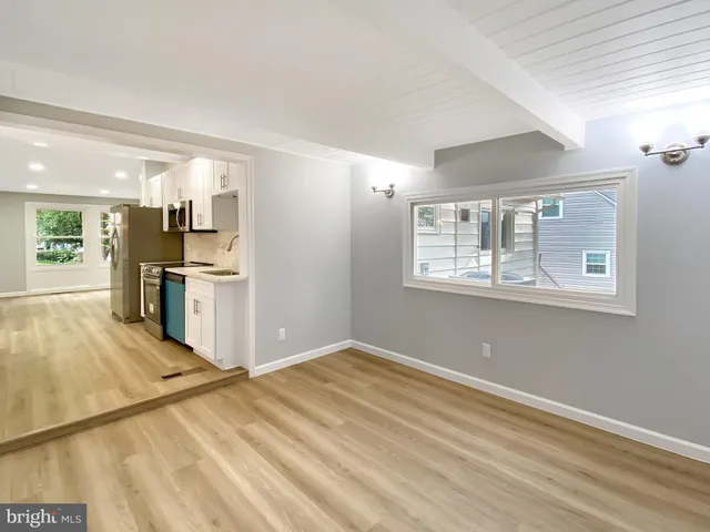 a view of a kitchen with wooden cabinet and a window
