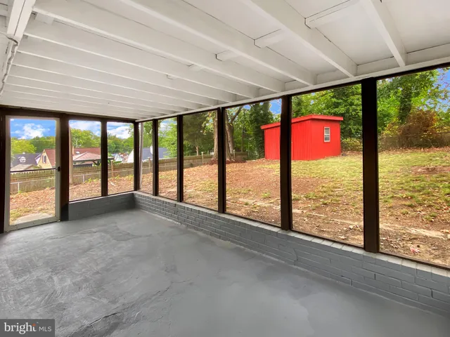 a view of an empty room with windows