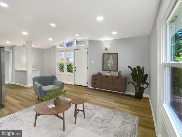 a living room with furniture potted plant and a window