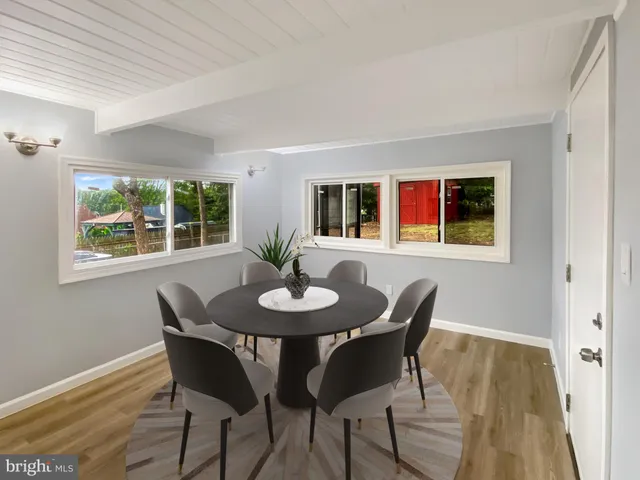 a view of a dining room with furniture and window