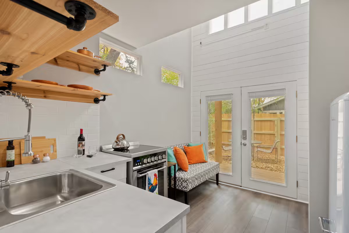 307 East 35th Street, Unit A Austin, TX 78705 - Photo 30 of 40 A compact kitchen with sleek counters and a French door leading to an inviting outdoor space.