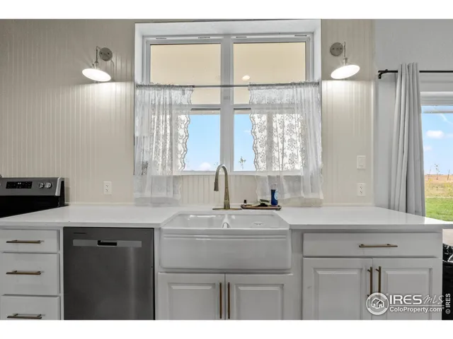 a kitchen with a sink cabinets and a window