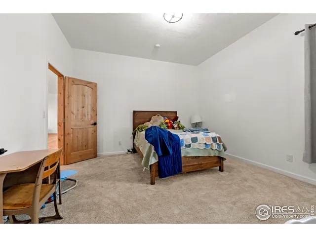 a bedroom with a bed and a table in it