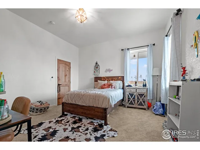 a bedroom with bed and a chandelier